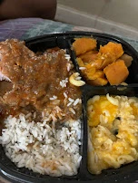 Smothered Pork Chop Dinner over White Rice with Mac N Cheese and Yams